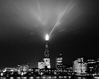 Low angle view of illuminated city against sky at night