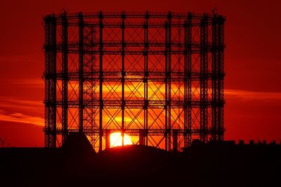 Low angle view of silhouette built structure against sky during sunset