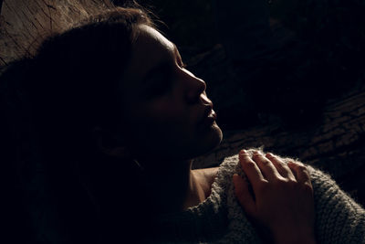 Close-up portrait of young woman looking away