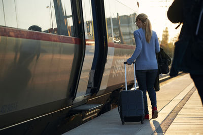 Woman entering train at station