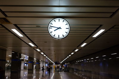 Low angle view of clock in illuminated building