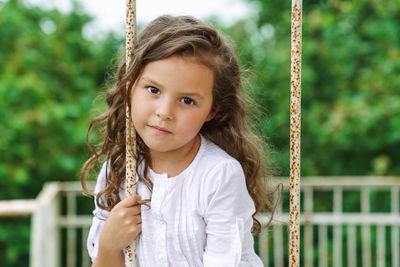 Portrait of girl on swing