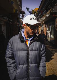 Man looking away while standing in winter