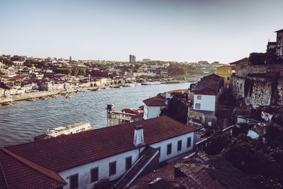 High angle view of buildings by town against sky