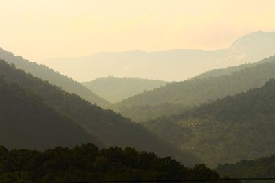 Scenic view of mountains against sky during foggy weather