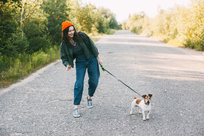 Full length of dog walking on road