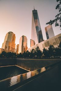 Skyscrapers in city against sky during sunset