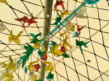 Low angle view of multi colored umbrellas hanging on tiled floor