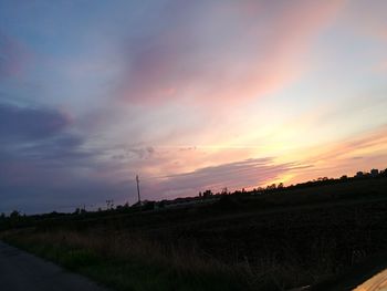 Scenic view of silhouette field against sky during sunset