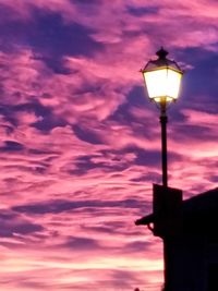 Low angle view of street light against cloudy sky