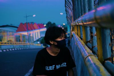 Portrait of a boy looking at blue illuminated light