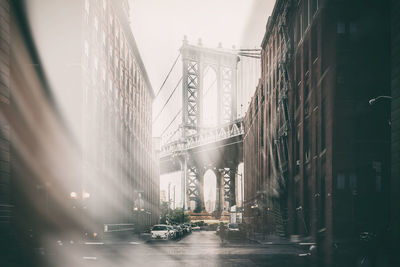 View of bridge in city against sky