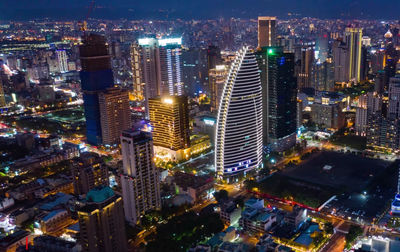 High angle view of illuminated buildings in city at night