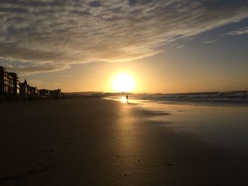 Scenic view of beach against sky during sunset
