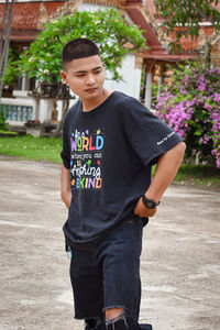 Portrait of young man standing on road