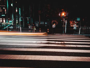 Zebra crossing on city street at night