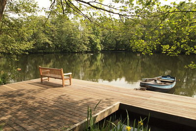 Boat moored in lake against trees
