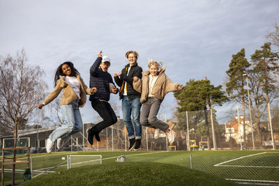 Portrait of teenage friends jumping