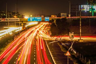 Illuminated light trail on highway at night