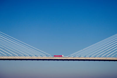 Suspension bridge against clear blue sky