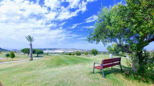 Scenic view of landscape by sea against sky