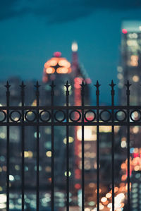 Defocused image of illuminated city against sky at night