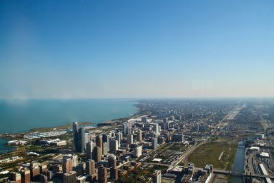 High angle view of buildings by sea against sky