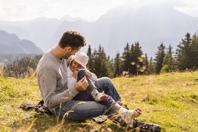 Playful father with daughter in meadow