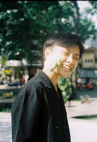 Portrait of smiling young man standing outdoors