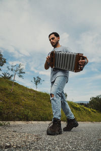 Side view of man standing on road