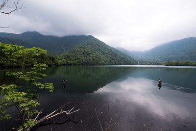 Scenic view of lake and mountains against sky