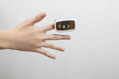 Close-up of woman hand against white background