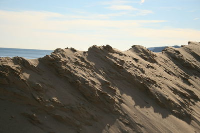 Scenic view of rocky beach against sky