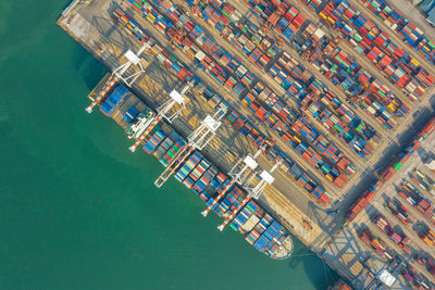 Container ship in export and import business and logistics. shipping cargo to harbor by crane.