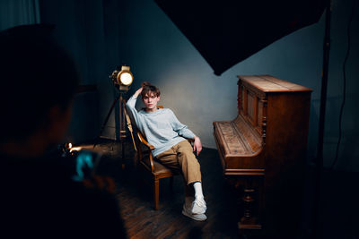 Man sitting on chair at home