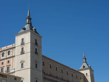 Low angle view of buildings against blue sky