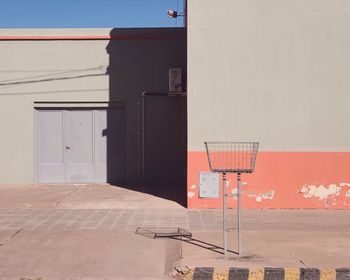 View of basketball hoop by building against sky