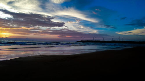 Scenic view of beach against sky during sunset