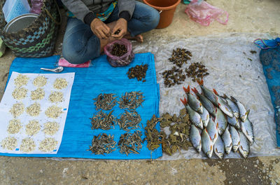 High angle view of man preparing fish for sale in market