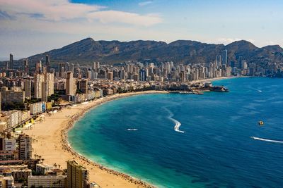 High angle view of sea and cityscape against sky