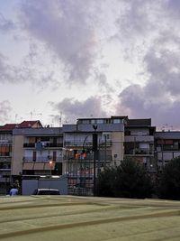 Buildings against cloudy sky