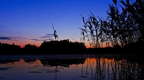 Scenic view of lake at sunset