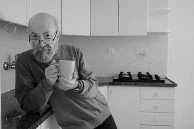 Young man drinking coffee at home