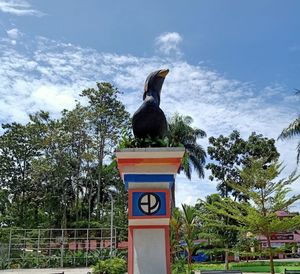 Low angle view of bird statue against sky