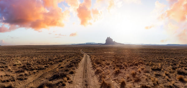 Scenic view of land against sky during sunset