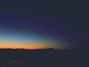 Silhouette landscape against clear sky at sunset