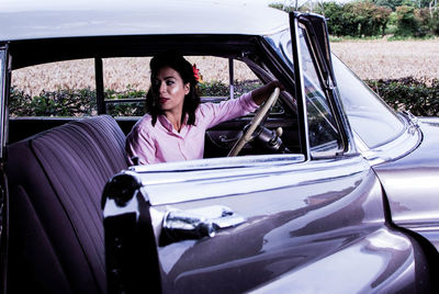 Portrait of woman sitting in car