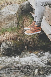 Low section of man standing on water