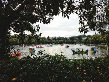 Boats moored in lake against sky