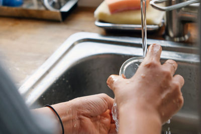 Cropped hand washing hands